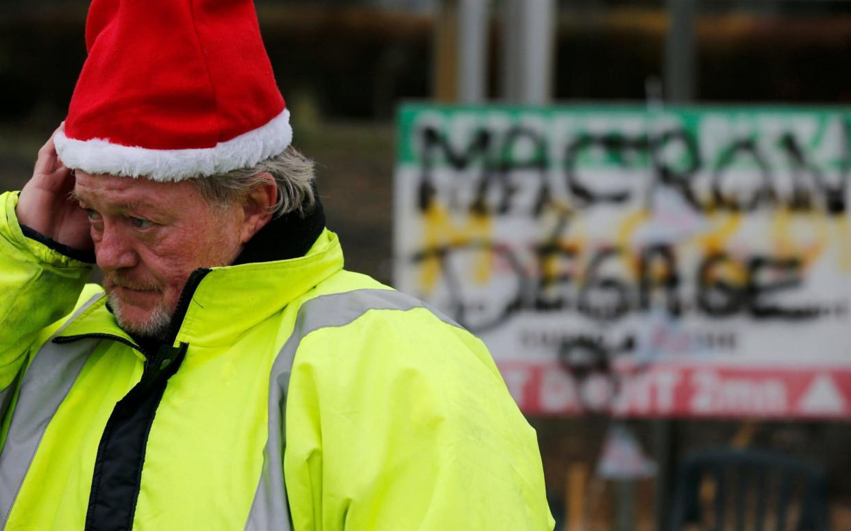 A protester wearing a yellow vest, the symbol of a French drivers' protest against higher diesel fuel prices, occupies with comrades a roundabout in Somain - REUTERS