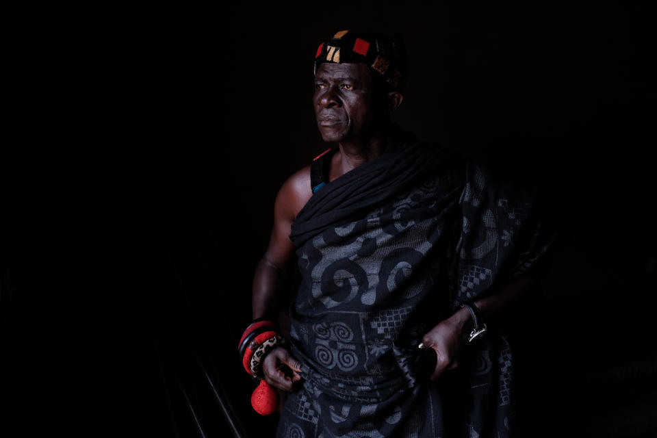 Nana Assenso, chief of Adidwan, a village in Ghana's interior, looks on before visiting the grave of his uncle Kwame Badu. (Photo: Francis Kokoroko/Reuters)