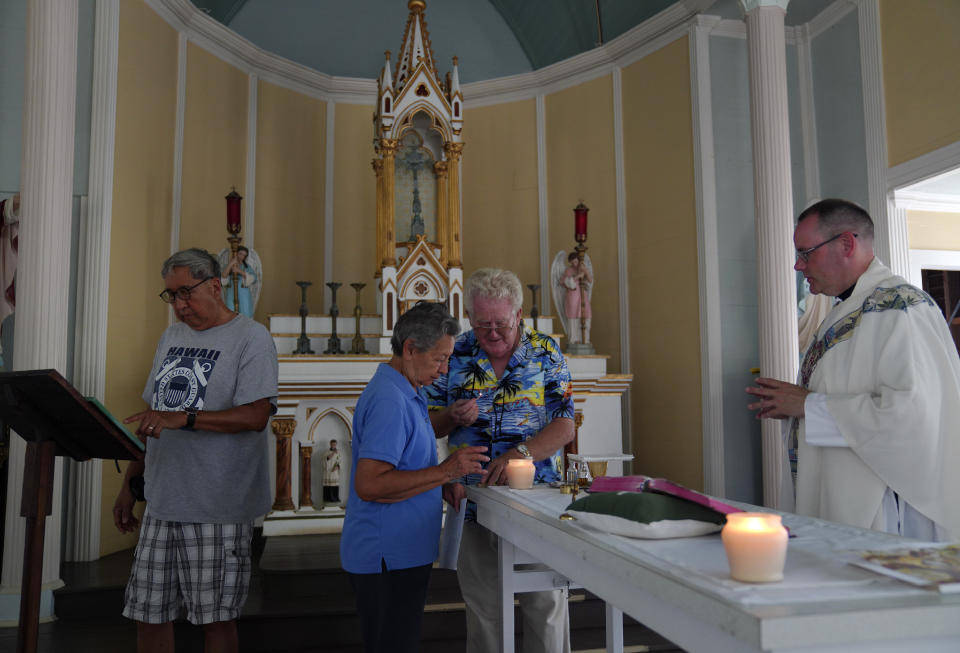 From left, Lance Toyofuku, Sister Alicia Damien Lau, the Rev. Patrick Killilea, and the Rev. Stephen Cotter, prepare for an impromptu Mass held at St. Philomena Church on Kalaupapa, Hawaii, on Tuesday, July 18, 2023. Banishing the sick to the isolated Kalaupapa settlement was once the government's answer to a deadly leprosy outbreak in the 1800s that persisted into the next century. (AP Photo/Jessie Wardarski)