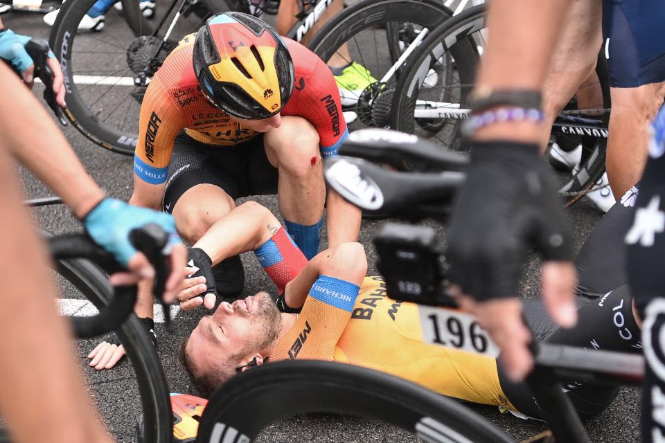 Team Bahrain rider Italy's Sonny Colbrelli lies on the road in pain after crashing.