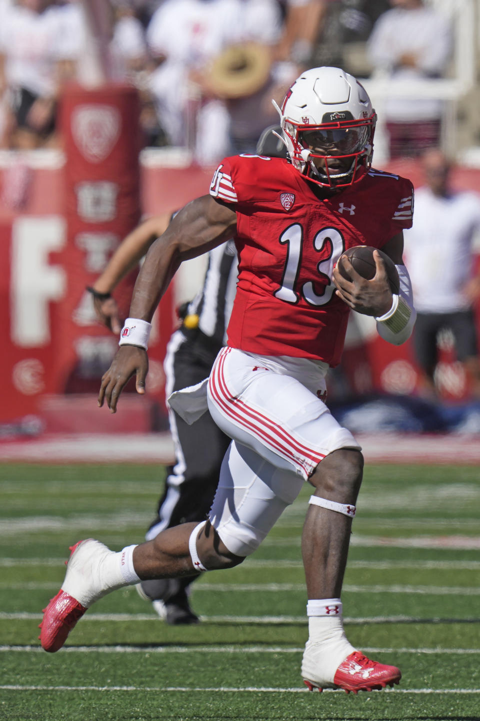 Utah quarterback Nate Johnson (13) carries the ball during the first half of an NCAA college football game against UCLA, Saturday, Sept. 23, 2023, in Salt Lake City. (AP Photo/Rick Bowmer)
