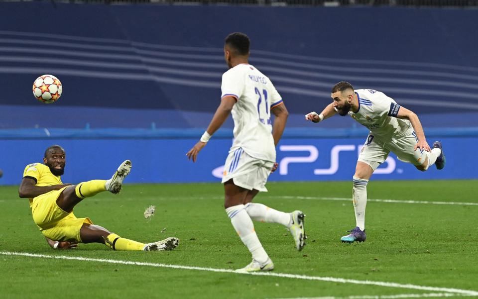 Karim Benzema of Real Madrid scores their team's second goal during the UEFA Champions League Quarter Final Leg Two match between Real Madrid and Chelsea FC at Estadio Santiago Bernabeu on April 12, 2022 in Madrid, Spain - David Ramos/Getty Images