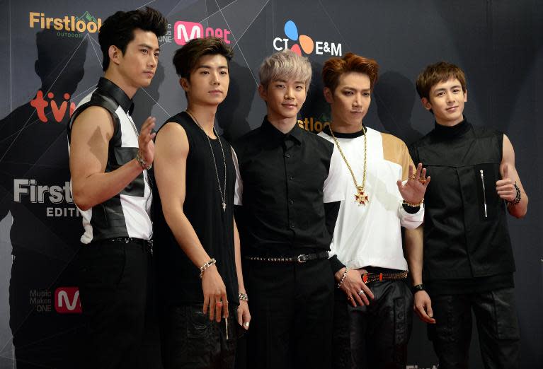 Members of South Korean K-Pop group 2PM pose during a press conference before attending the K-Pop chart show "M Countdown" at Yokohama Arena on April 2, 2014