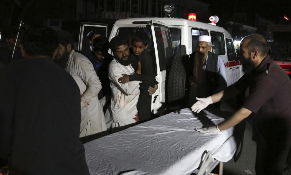 Afghan men carry an injured young boy into a hospital after a large explosion in Kabul, Afghanistan, Monday, Sept. 2, 2019. Afghan officials say a large explosion in Kabul has targeted the Green Village compound, home to several international organizations and guesthouses. (AP Photo/Rahmat Gul)