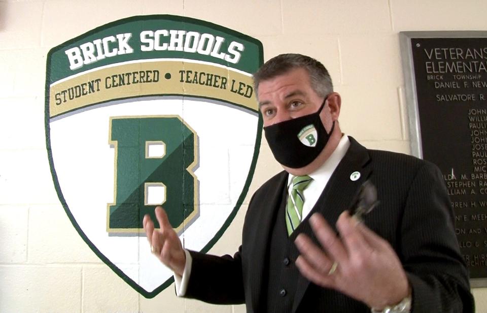 Brick Township Schools Superintendent Thomas Farrell speaks in front of a logo inside Veterans Memorial Elementary School  on Thursday, March 11, 2021.