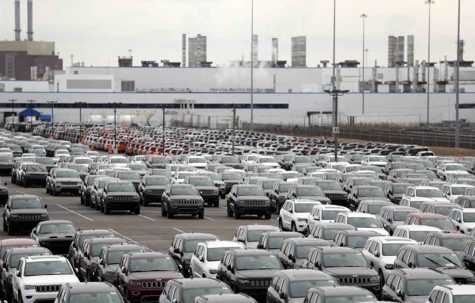 FILE - In this Feb. 26, 2019, file photo, Jeep vehicles are parked outside the Jefferson North Assembly Plant in Detroit. Defying a wave of layoffs that has sent the U.S. job market into its worst catastrophe on record, at least one major industry is making a comeback: Tens of thousands of auto workers are returning to factories that have been shuttered since mid-March due to fears of spreading the coronavirus. (AP Photo/Carlos Osorio, File)