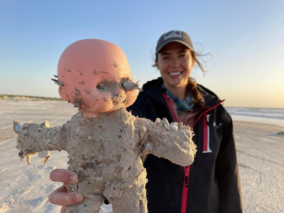 A researcher with Mission-Aransas Reserve at the University of Texas Marine Institute holds a doll covered in barnacles growing out of its eyes found in April, 2022, while surveying coasts for creatures like sea turtles, marine mammals and endangered bird species, along a 40-mile stretch of beach from north Padre Island to Matagorda Island. Compared to the rest of the Gulf of Mexico, Texas coastal bend beaches get 10 times the amount of trash, a reality caused by a "loop current" that extends from the Yucatan Peninsula to Florida and pushes debris toward the Texas Gulf, Jace Tunnell, director of the Mission-Aransas Reserve at the University of Texas Marine Institute, told the Star-Telegram. Tunnell sells the dolls at a yearly fundraising auction and has collected 30 dolls since he began to keep count of them.