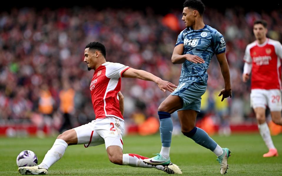 William Saliba of Arsenal tackles Ollie Watkins of Aston Villa