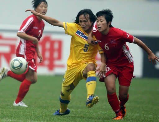 Thailand's Kanjana Sung-ngoen (C) fights for the ball with North Korea's Yun Song-mi during a qualifier for the 2012 London Olympic Games, in Jinan, eastern China's Shandong province, in 2011. Pyongyang announced in early June that 51 athletes had qualified in 11 sports for London, with its main medal hopes in weightlifting, wrestling and women's football