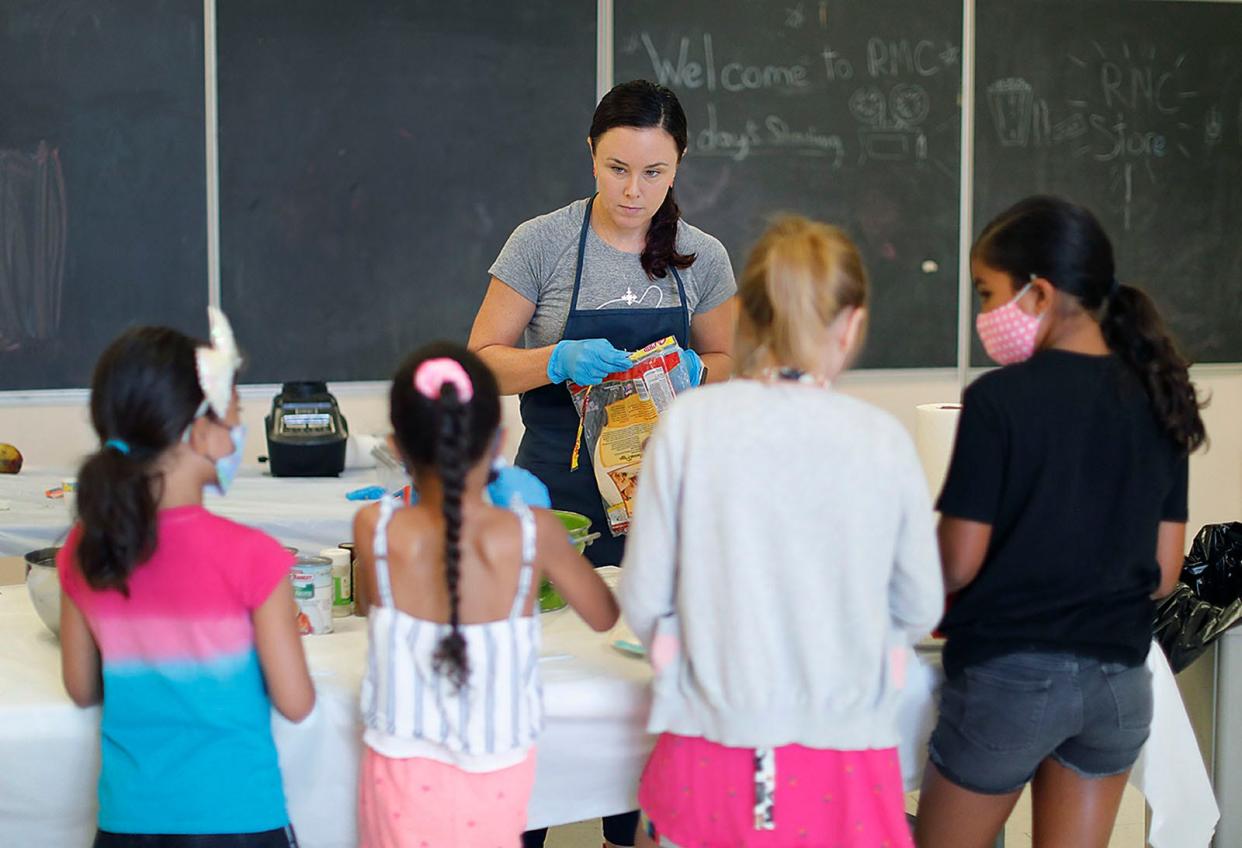 Mary-Kate Fay of the Kids' Test Kitchen program works with youngsters at the Rockland Community Center. She's teaching them how to select good food and prepare a healthy meal Wednesday, July 20, 2022.