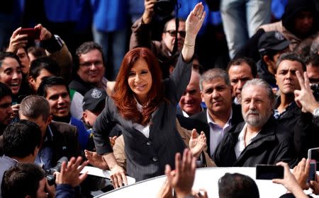 Former Argentine President Cristina Fernandez de Kirchner waves to supporters as she leaves a Justice building in Buenos Aires, Argentina, April 13, 2016. REUTERS/Marcos Brindicci