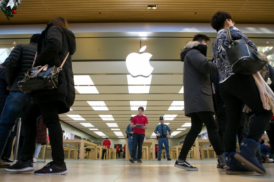 Shoppers wait in line for the Apple Store to open at Christiana Mall on Black Friday in 2018.