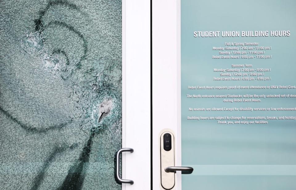 A shattered door is viewed at the student union building the morning after a shooting left three dead at the University of Nevada (Getty Images)