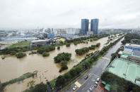 In this picture taken through a window, trails along the Osan Stream are flooded after heavy rains in Osan, South Korea, Thursday, July 18, 2024. (Hong Gi-won/Yonhap via AP)