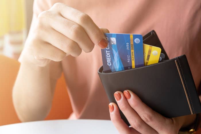 Person taking credit cards out of their wallet