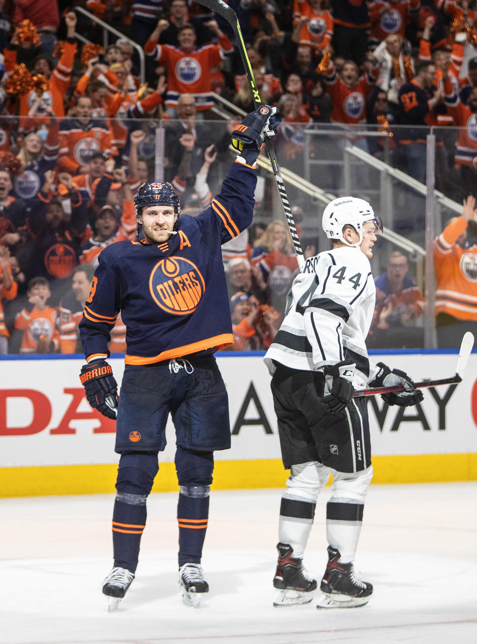 Los Angeles Kings' Mikey Anderson (44) skates by as Edmonton Oilers' Leon Draisaitl (29) celebrates a goal during the second period of Game 1 of an NHL hockey Stanley Cup first-round playoff series, Monday, May 2, 2022 in Edmonton, Alberta. (Jason Franson/The Canadian Press via AP)
