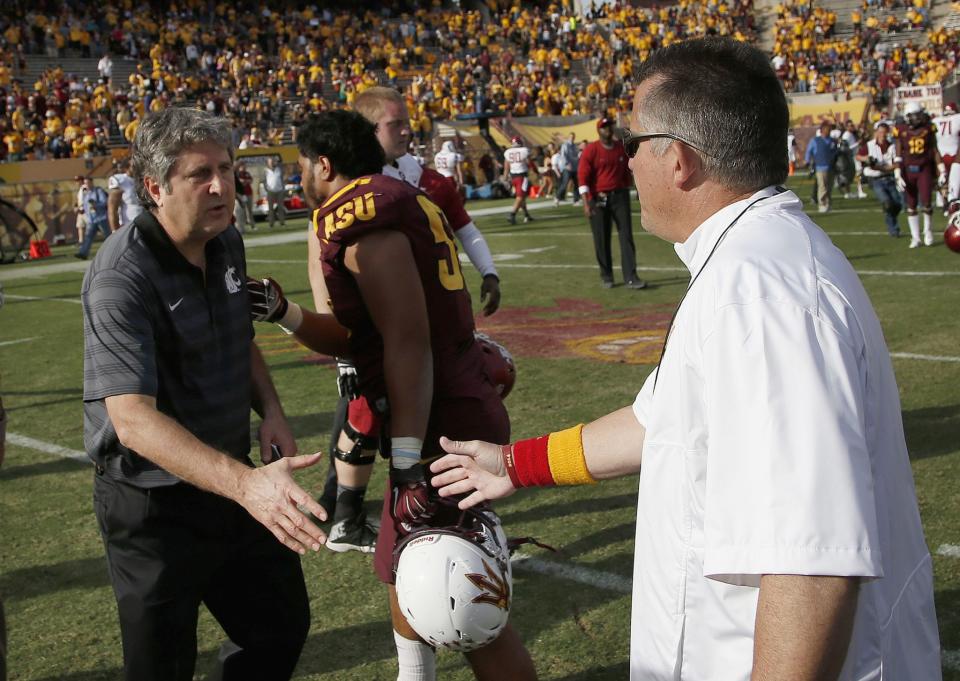 Things were a bit more cordial between Mike Leach and Todd Graham back in 2014, when this photo was taken. (AP Photo/Ross D. Franklin)