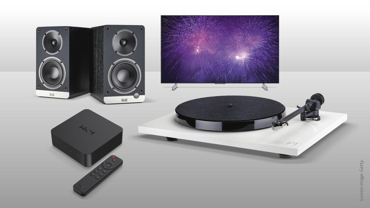  Elac Debut ConneX speakers, WiiM Pro Plus streamer, Rega Planar 1 Plus turntable and LG OLED42C3 TV on grey background. 