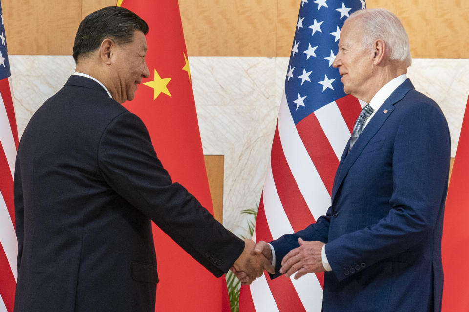 FILE - U.S. President Joe Biden, right, and Chinese President Xi Jinping shake hands before a meeting on the sidelines of the G20 summit meeting, on Nov. 14, 2022, in Bali, Indonesia. China has sanctioned two U.S. individuals in retaliation for action taken by Washington over human rights abuses in Tibet, the government said Friday, Dec. 23. (AP Photo/Alex Brandon, File)