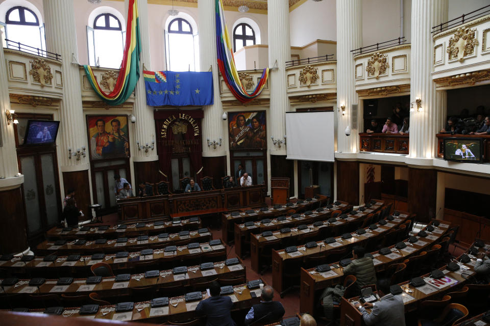 Congress sits partially empty, after lawmakers from the MAS political party, that of former President Evo Morales, did not arrive for session as a form of protest in La Paz, Bolivia, Tuesday, Nov. 12, 2019. Morales, who transformed Bolivia as its first indigenous president, flew to exile in Mexico on Tuesday after weeks of violent protests, leaving behind a confused power vacuum in the Andean nation. Morales backers still have a majority in the body. (AP Photo/Juan Karita)