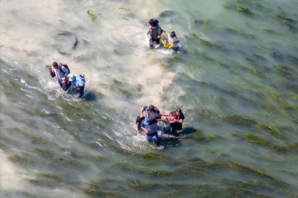 Immigrants struggle through the current of the Rio Grande while crossing from Mexico into the United States in Eagle Pass, Texas, on Sept. 27.<span class="copyright">John Moore—Getty Images</span>