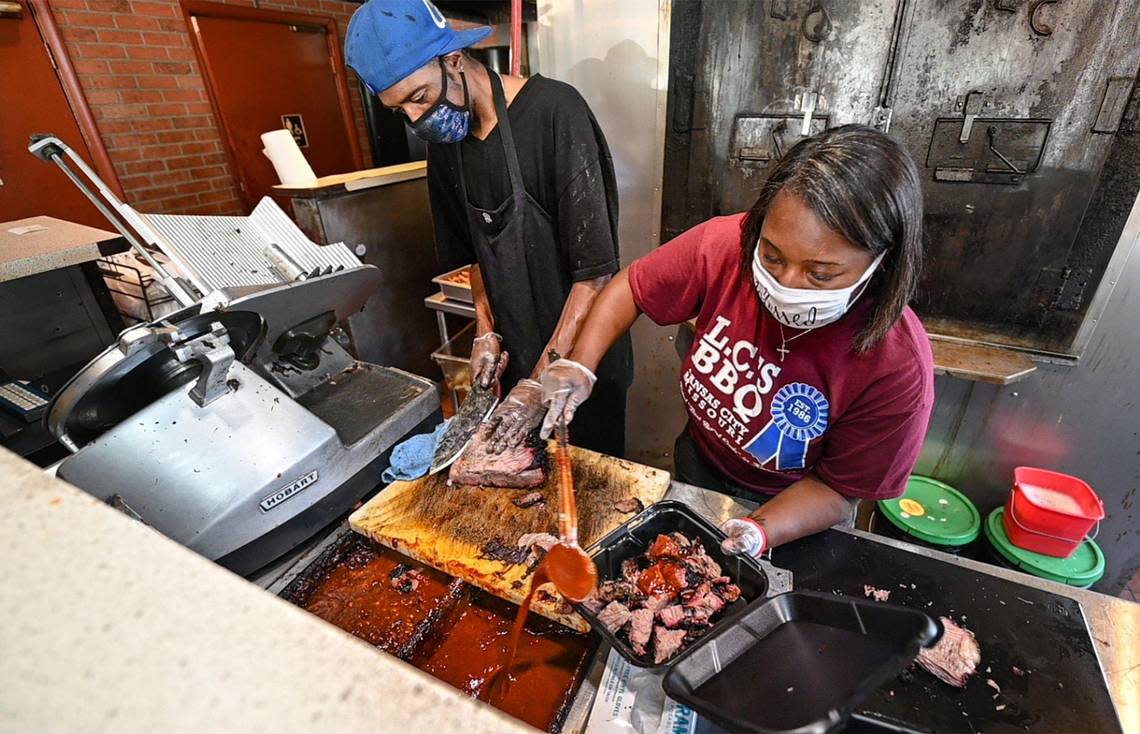 Tausha Hammett now runs LC’s Bar-B-Q, where she filled an order alongside pit master Lorenzo Pettis. Hammett, who has worked there since she was 12, was picked by her late grandfather, restaurant founder L.C. Richardson, to take over after his death in February.