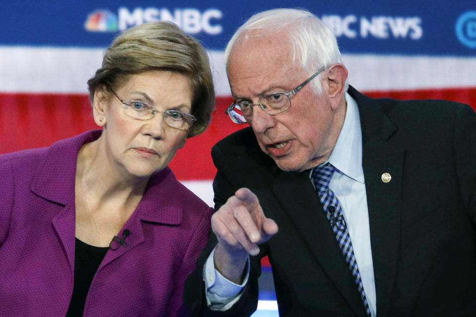 FILE - In this Feb. 19, 2020 file photo, Democratic presidential candidates, Sen. Elizabeth Warren, D-Mass., left, and Sen. Bernie Sanders, I-Vt., talk during a Democratic presidential primary debate in Las Vegas, hosted by NBC News and MSNBC. Choosing a presidential candidate based primarily on loathing the alternative is not the strongest of electoral strategies. That's why leaders of the progressive movement say many Americans who were enthralled by Bernie Sanders and his slogan of “Not Me. Us,” won’t be as likely to settle for Joe Biden. (AP Photo/John Locher)