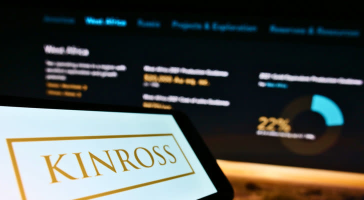 Cellphone with business logo of Canadian mining company Kinross Gold Corp. on screen in front of webpage.