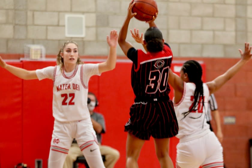 Centennial's Jayda Curry shoots a 3-pointer over Mater Dei's Brooke Demetre (left) and Ayana Johnson.