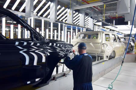 A Ford worker inspects paint work on the body of a Ford Expedition SUV at Ford's Kentucky Truck Plant as the No. 2 U.S. automaker ramps up production of two large SUV models in Louisville, Kentucky, U.S., February 9, 2018. REUTERS/Nick Carey