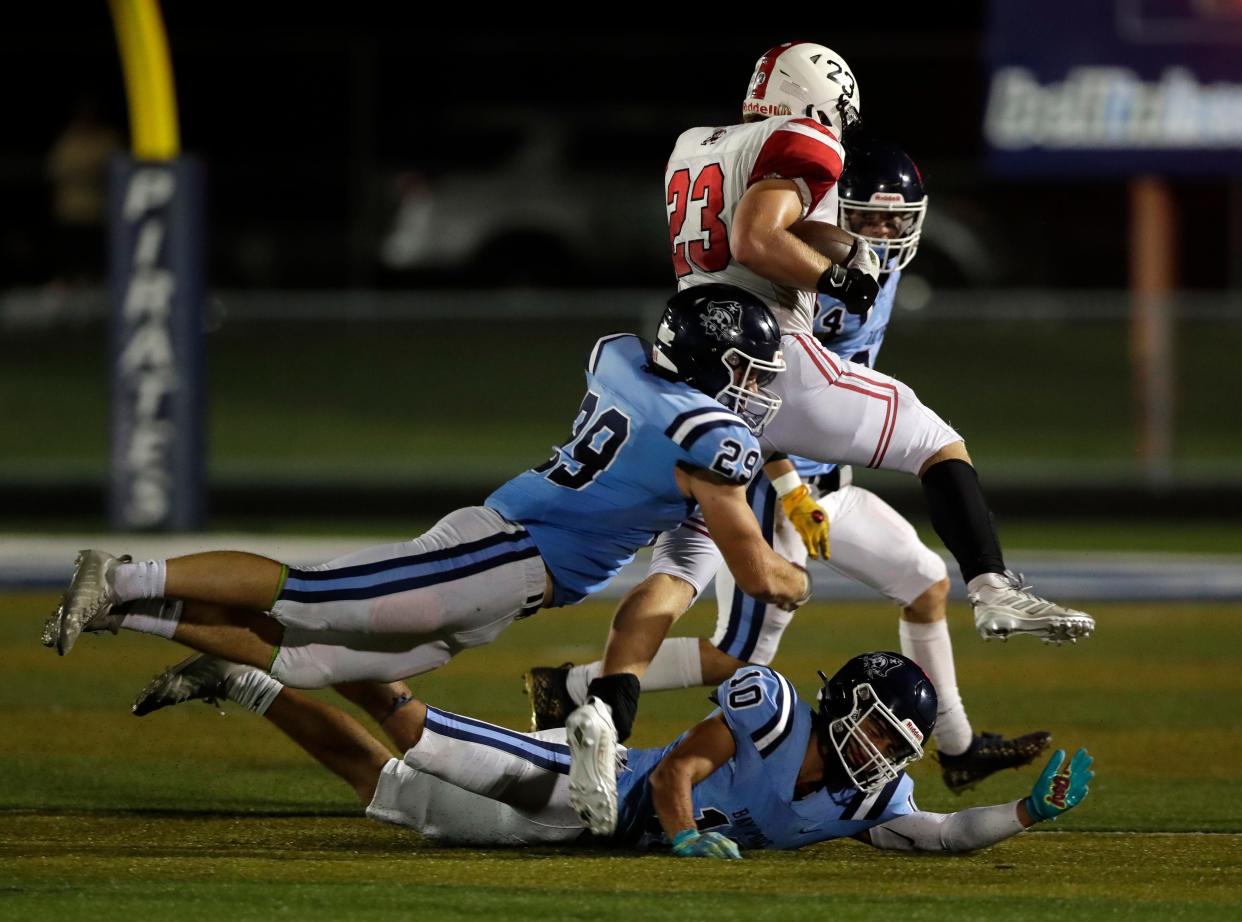 Pulaski's Jake Adams (23) is brought down by Bay Port's Josiah Azure (29) during a game on Sept. 9. Azure was selected the defensive player of the year on the WFCA Large Schools all-state team.