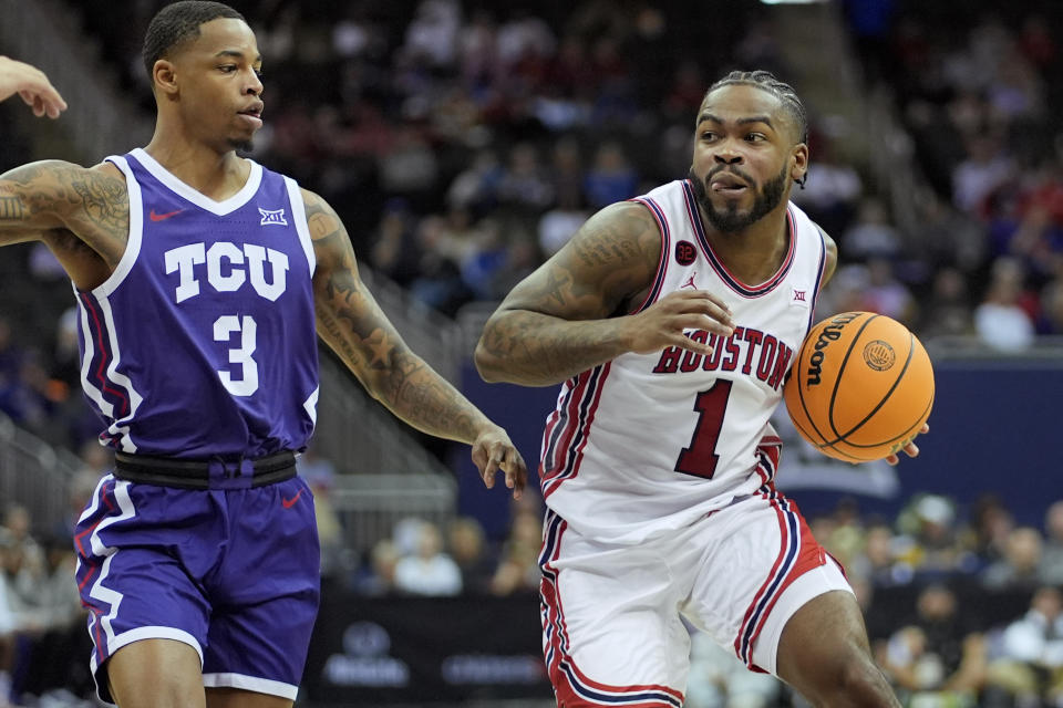 Houston guard Jamal Shead (1) gets past TCU guard Avery Anderson III (3) during the second half of an NCAA college basketball game in the quarterfinal round of the Big 12 Conference tournament, Thursday, March 14, 2024, in Kansas City, Mo. Houston won 60-45. (AP Photo/Charlie Riedel)
