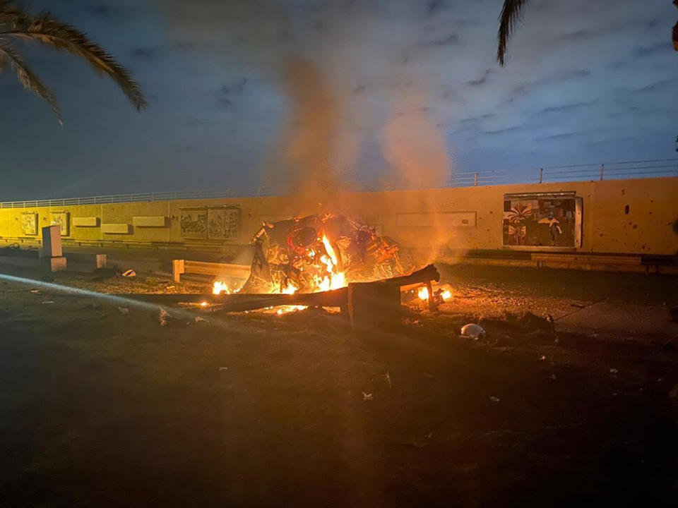 This photo released by the Iraqi Prime Minister Press Office shows a burning vehicle at the Baghdad International Airport following an airstrike in Baghdad, Iraq, early Friday, Jan. 3, 2020. The Pentagon said Thursday that the U.S. military has killed Gen. Qassem Soleimani, the head of Iran's elite Quds Force, at the direction of President Donald Trump. (Iraqi Prime Minister Press Office via AP)