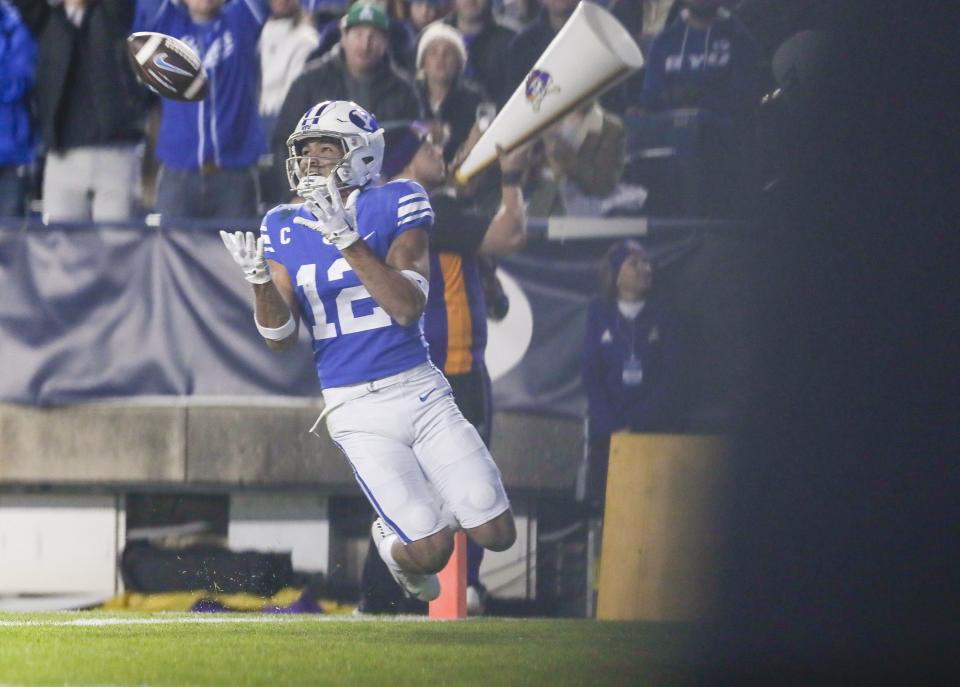 BYU wide receiver Puka Nacua catches a ball for a touchdown against the East Carolina Pirates in an NCAA college football game on Friday, Oct. 28, 2022, in Provo, Utah. The Pirates won 27-24.