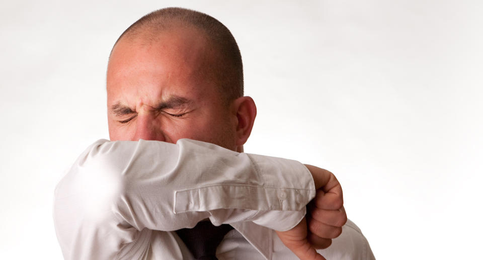 NSW Health is encouraging Aussies to sneeze into their elbow, instead of their hand, to prevent the spread of germs. Source: Getty