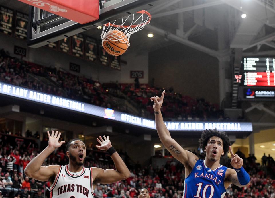 Texas Tech's forward Kevin Obanor (0), left, and Kansas forward Jalen Wilson (10) react to Obanor's dunk, Tuesday, Jan. 3, 2023, at United Supermarkets Arena.