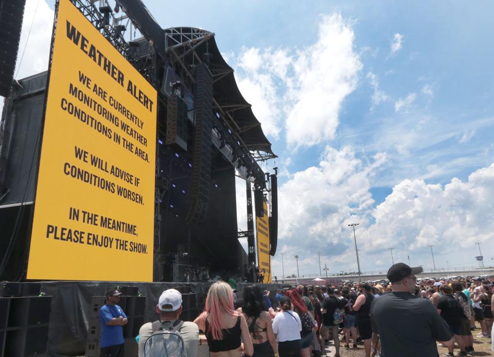 A weather warning flashes to the crowd as clouds build west of Daytona International Speedway on the opening day of Welcome to Rockville in 2023. Fans headed to the event are urged to make a plan for inclement weather.