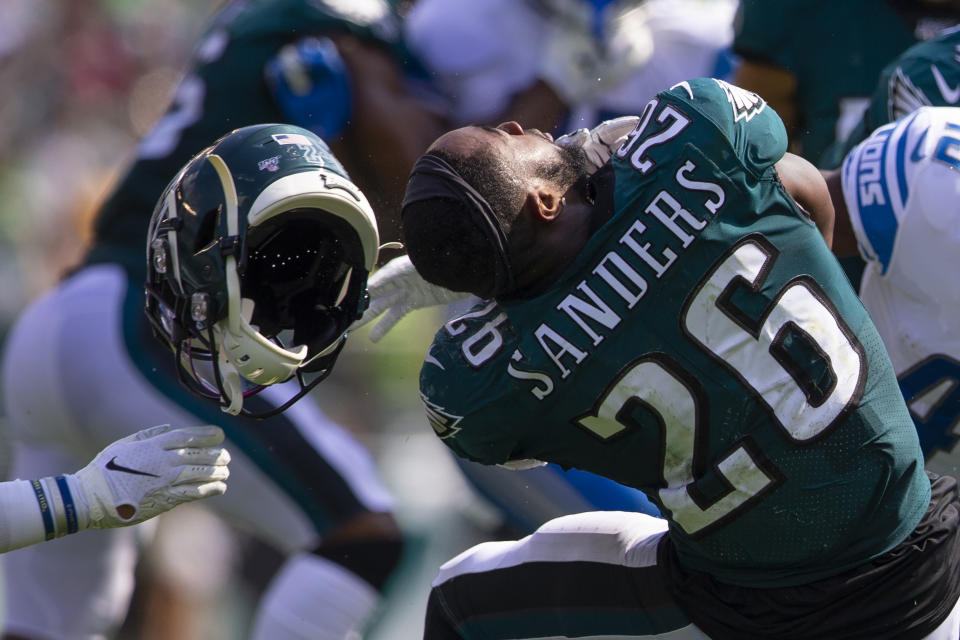 Miles Sanders nearly had his head unscrewed from his body during blatant facemask violation, but the refs didn't call a penalty. (Photo by Mitchell Leff/Getty Images)