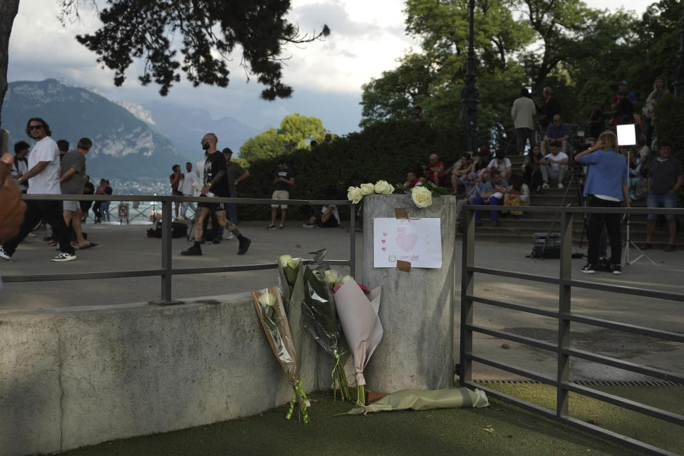 Flowers lay at the playground after a knife attack Thursday, June 8, 2023 in Annecy, French Alps. A a man with a knife stabbed four young children at a lakeside park in the French Alps on Thursday, assaulting at least one in a stroller repeatedly. The children between 22 months and 3 years old suffered life-threatening injuries, and two adults also were wounded, authorities said. (AP Photo/Laurent Cipriani)