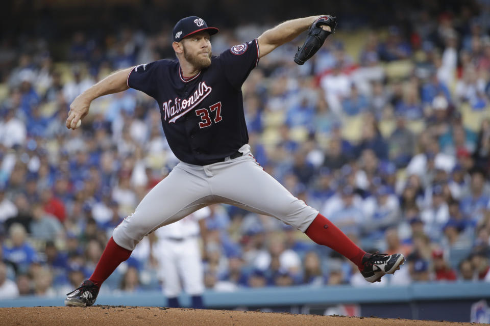 FILE - In this Oct. 9, 2019, file photo, Washington Nationals starting pitcher Stephen Strasburg throws to a Los Angeles Dodgers batter during the first inning in Game 5 of a baseball National League Division Series, in Los Angeles. World Series MVP Stephen Strasburg is staying with the Washington Nationals. The right-hander has agreed to a record $245 million, seven-year contract, a person familiar with the negotiations told The Associated Press on Monday, Dec. 9, 2019. The person spoke on condition of anonymity at baseball's annual winter meetings because the agreement had not been announced. (AP Photo/Marcio Jose Sanchez, File)