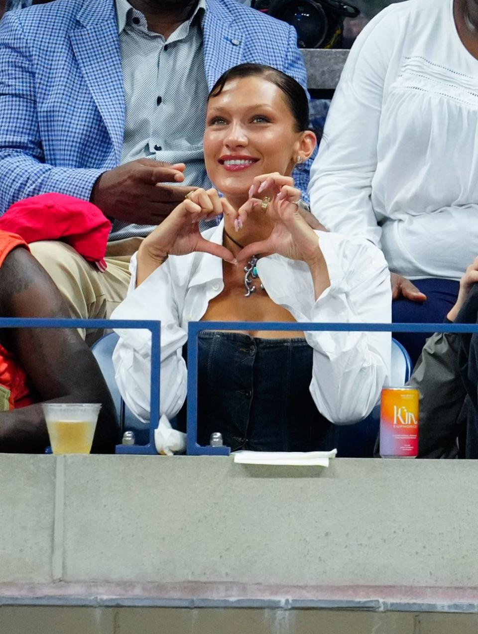 NEW YORK, NEW YORK - AUGUST 29: Bella Hadid and Marc Kalman look on during the Women's Singles First Round match between Serena Williams of the United States and Danka Kovinic of Montenegro on Day One of the 2022 US Open at USTA Billie Jean King National Tennis Center on August 29, 2022 in the Flushing neighborhood of the Queens borough of New York City. (Photo by Gotham/GC Images)