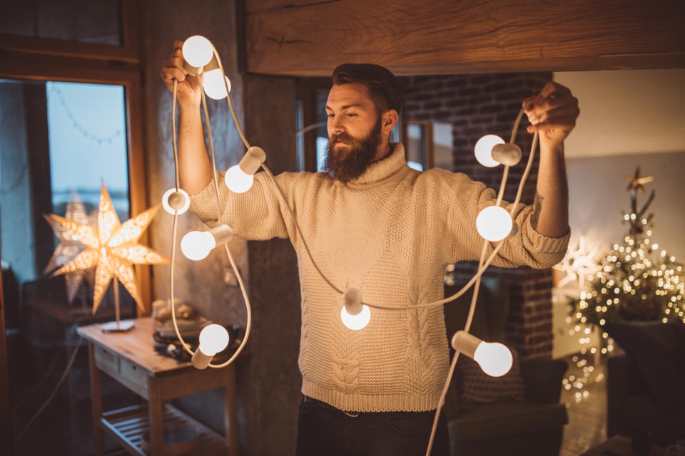 Man with Christmas lights. (Getty Images)