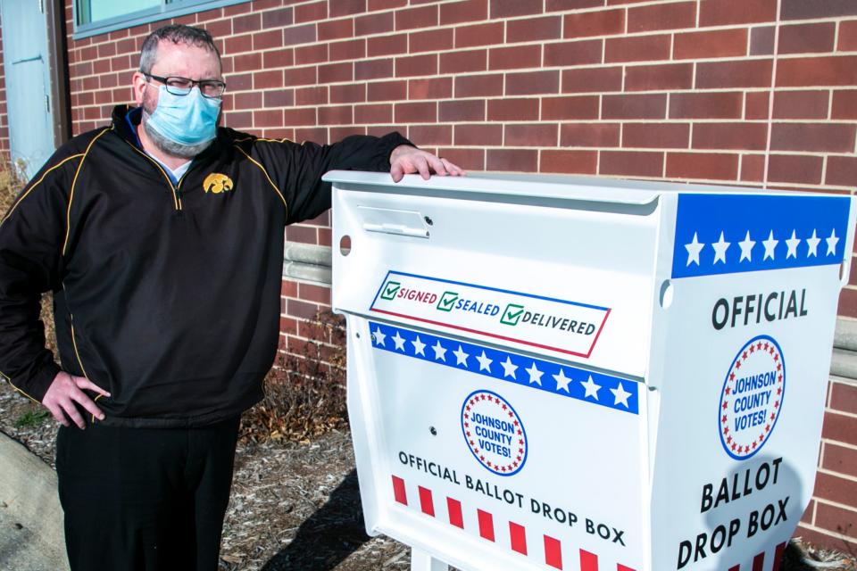 Johnson County Auditor Travis Weipert poses for a photo with the official ballot drop box, Thursday, Dec. 10, 2020, at the Johnson County Administration Building in Iowa City, Iowa.