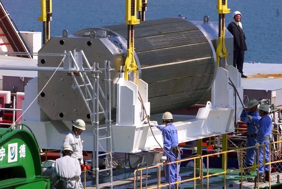 FILE - In this Sept. 27, 1999, a container of uranium oxide and plutonium (MOX) is unloaded from British plutonium transport ship Pacific Teal at a port in Iwaki, reserved for the use by Tokyo Electric Power Co.'s Fukushima Dai-ichi nuclear power plant in Fukushima prefecture, northeastern Japan. Last year's tsunami crisis left Japan's nuclear future in doubt and its reactors idled, rendering its huge stockpile of plutonium useless for now. So, the nuclear industry's plan to produce even more this year has raised a red flag. Nuclear industry officials say they hope to start producing a half-ton of plutonium within months, in addition to the more than 35 tons Japan already has stored around the world. That's even though all of the reactors that might use it are either inoperable or offline while the country rethinks its nuclear policy in light of the tsunami-generated Fukushima crisis. (AP Photo/Shizuo Kambayashi, File)