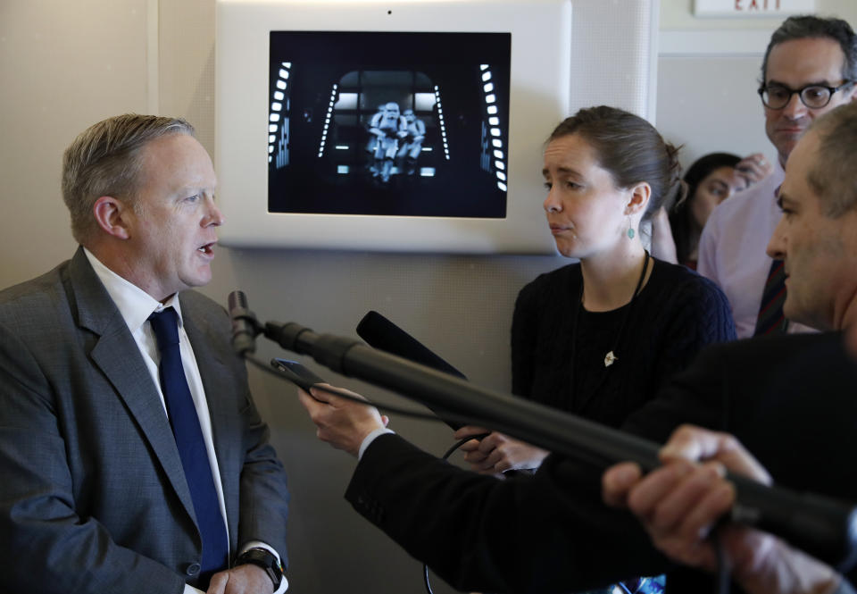 White House press secretary Sean Spicer speaks with reporters on Air Force One while in flight with President Donald Trump from Andrews Air Force Base, Md., to Palm Beach International Airport, Fla., Thursday, April 6, 2017. (AP Photo/Alex Brandon)