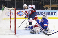 Daniel Sprong, left, of the Washington Capitals scores an unassisted goal in the third period against Igor Shesterkin, right, of the New York Rangers during an NHL hockey game Monday, May 3, 2021, in New York. (Bruce Bennett/Pool Photo via AP)