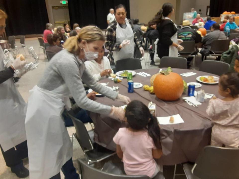 Volunteers serve food at the free Thanksgiving meal at Modesto Centre Plaza on Nov. 24, 2022.