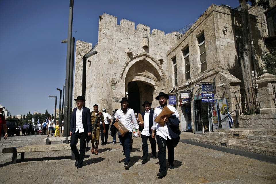 Ultra-Orthodox Jewish men carry bags as they walk near Jaffa Gate in Jerusalem's Old City. (Photo: Nir Elias/Reuters)