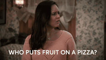 A woman saying, "who puts fruit on pizza"