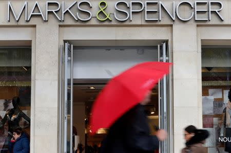 FILE PHOTO: Pedestrians walk past a Marks & Spencer store on the Champs Elysees avenue in Paris, France, November 8, 2016. REUTERS/Philippe Wojazer/File Photo